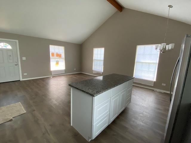 kitchen with beam ceiling, an inviting chandelier, dark hardwood / wood-style flooring, decorative light fixtures, and white cabinets