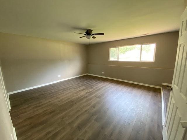 unfurnished room with ceiling fan and dark wood-type flooring