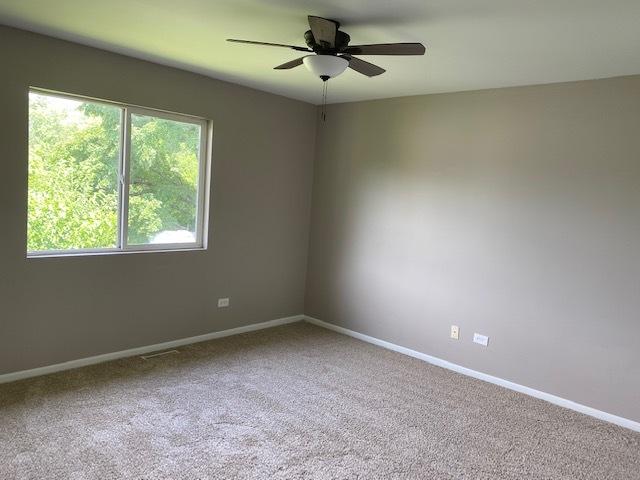 empty room with carpet and ceiling fan