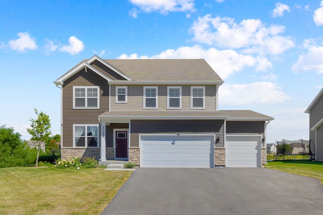 view of front of home featuring a garage and a front lawn