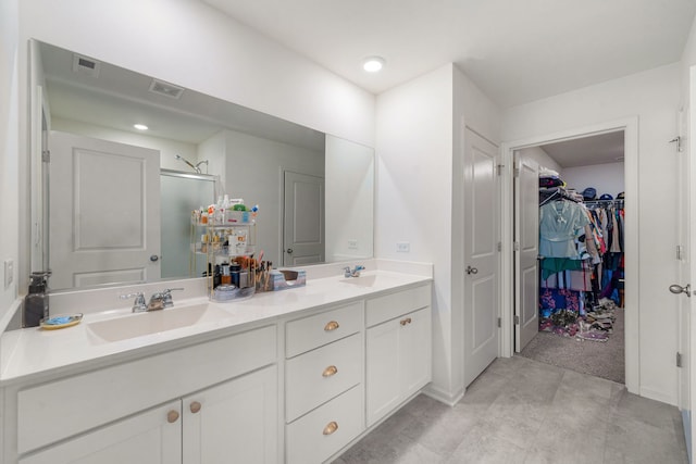 bathroom with vanity and a shower with shower door