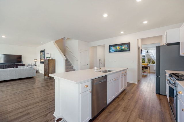 kitchen featuring stainless steel appliances, sink, a center island with sink, white cabinets, and dark hardwood / wood-style floors