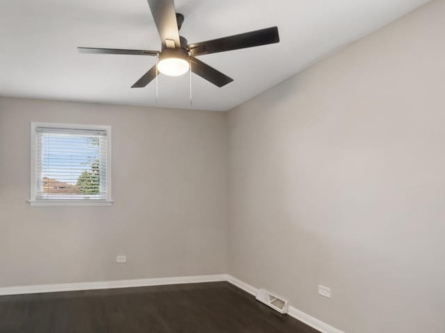 unfurnished room with dark hardwood / wood-style floors and ceiling fan