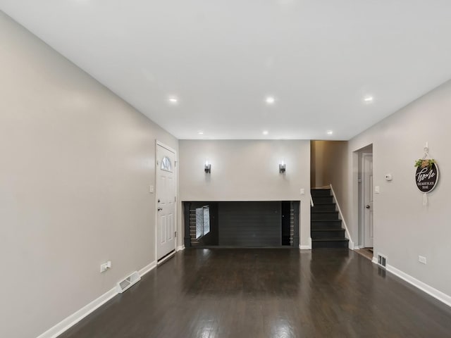 unfurnished living room featuring dark wood-type flooring