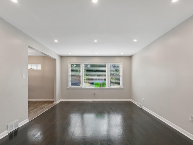 empty room featuring dark hardwood / wood-style flooring