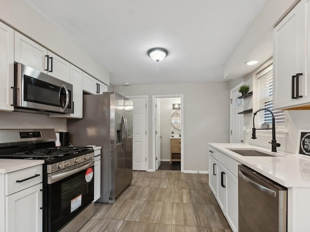 kitchen with white cabinets, stainless steel appliances, and sink