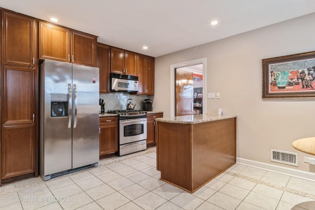 kitchen with stainless steel appliances, visible vents, decorative backsplash, and light tile patterned floors