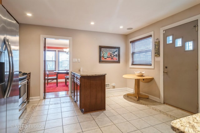 interior space featuring recessed lighting, tile patterned flooring, and baseboards