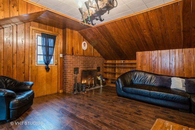 living area featuring a brick fireplace, vaulted ceiling, wood walls, and hardwood / wood-style flooring