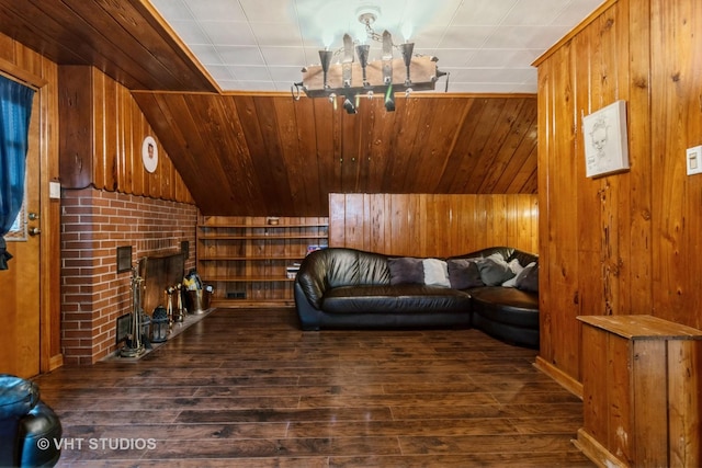 sitting room with an inviting chandelier, wood finished floors, and wooden walls