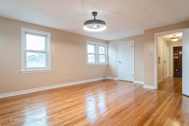 spare room with light wood-style flooring and baseboards