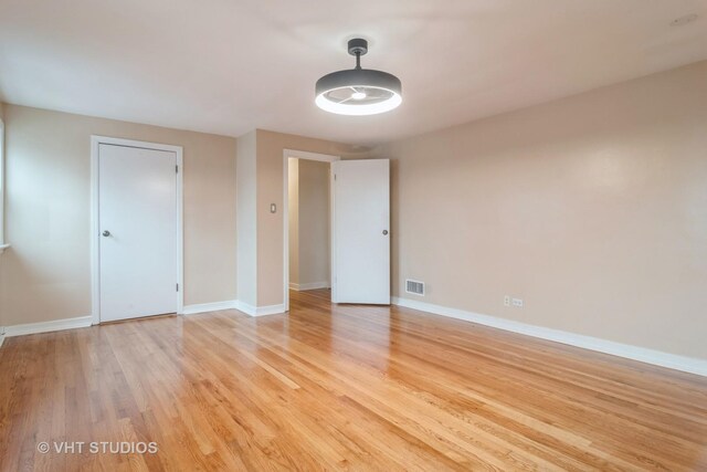 unfurnished bedroom with light wood-style floors, visible vents, and baseboards