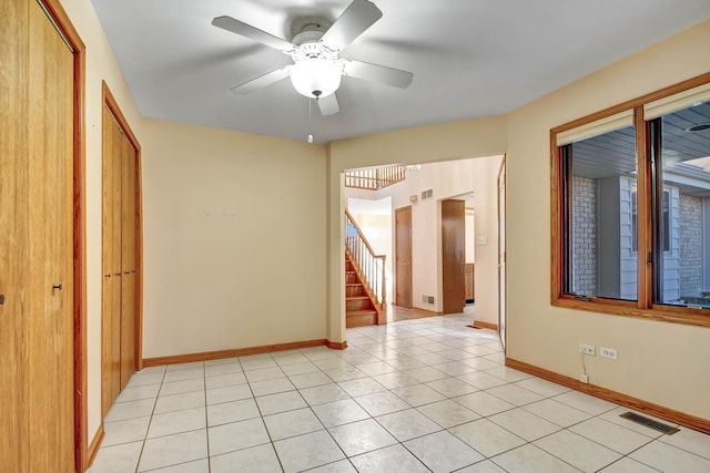 unfurnished room with ceiling fan and light tile patterned floors