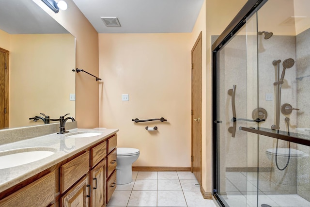 bathroom with tile patterned floors, vanity, toilet, and an enclosed shower