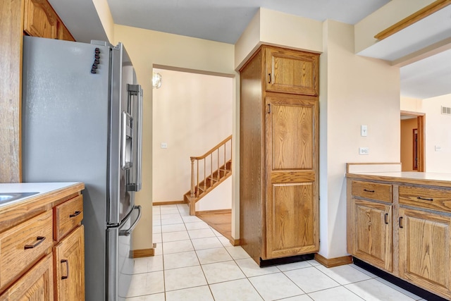 kitchen with stainless steel fridge and light tile patterned flooring