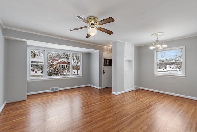 unfurnished room featuring light hardwood / wood-style flooring, ceiling fan with notable chandelier, and ornamental molding