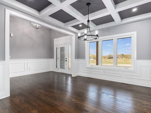 unfurnished dining area with a notable chandelier and dark wood-type flooring