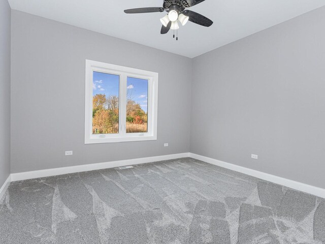 spare room featuring ceiling fan and carpet