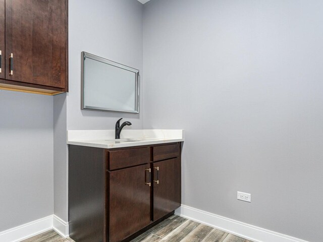 bathroom featuring hardwood / wood-style flooring and vanity