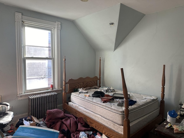 bedroom featuring radiator and vaulted ceiling