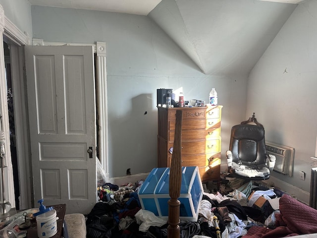 bedroom with lofted ceiling and an AC wall unit