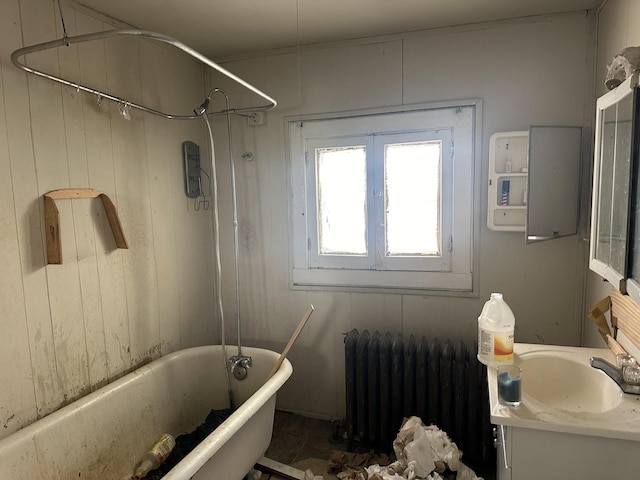 bathroom with bathing tub / shower combination, vanity, and radiator heating unit