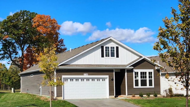 view of front of house featuring a garage and a front lawn