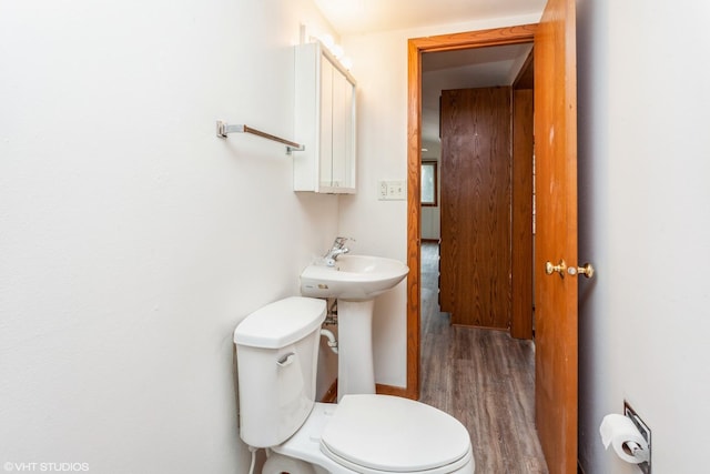 bathroom with wood-type flooring and toilet