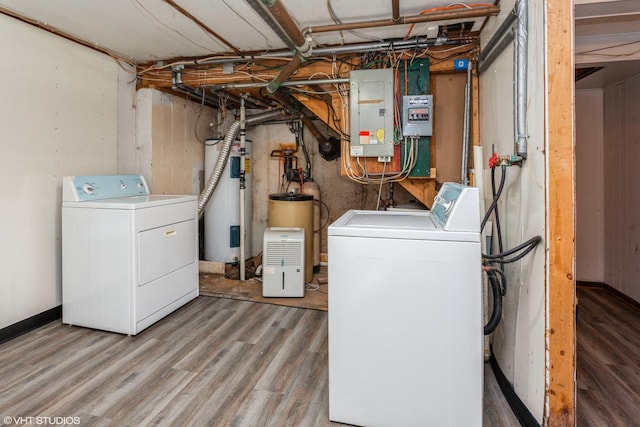 laundry area featuring electric panel, hardwood / wood-style floors, and washer and dryer