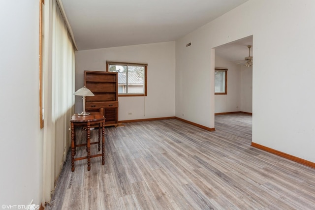 unfurnished room with ceiling fan, light hardwood / wood-style floors, and lofted ceiling