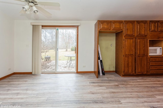 unfurnished dining area featuring light hardwood / wood-style flooring and ceiling fan