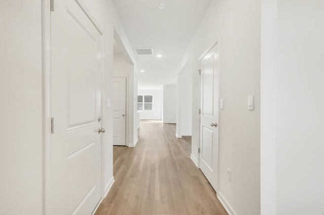 hallway with light hardwood / wood-style flooring