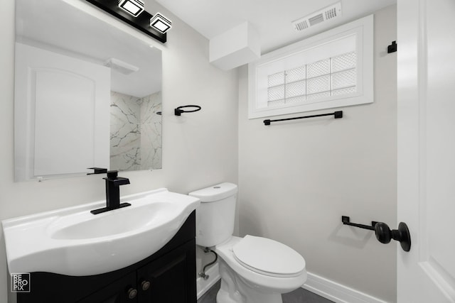 bathroom featuring toilet, baseboards, visible vents, and vanity