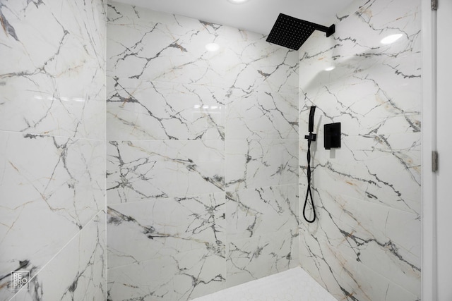 interior details featuring a marble finish shower