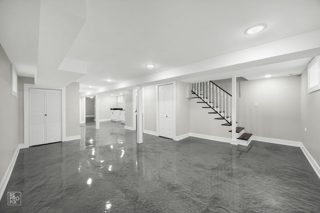 finished basement featuring marble finish floor, baseboards, stairway, and recessed lighting