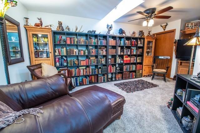 living area featuring ceiling fan and carpet floors