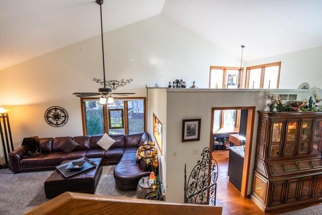 living room featuring ceiling fan, wood-type flooring, and high vaulted ceiling