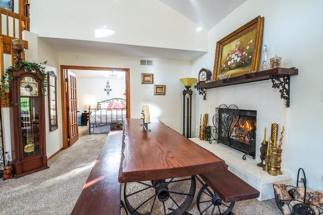 dining space featuring carpet flooring and vaulted ceiling