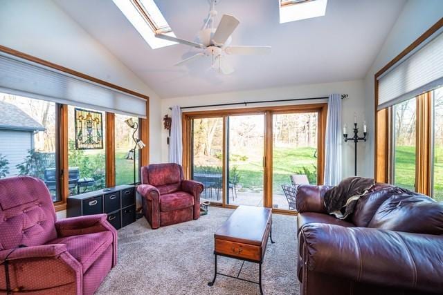 sunroom / solarium featuring vaulted ceiling with skylight and ceiling fan