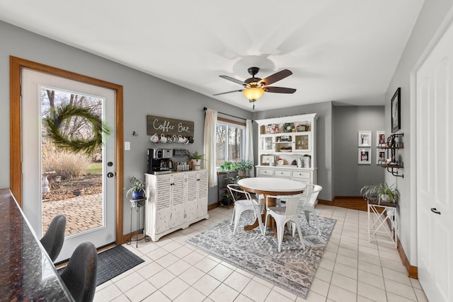 dining room with ceiling fan, light tile patterned floors, and a wealth of natural light