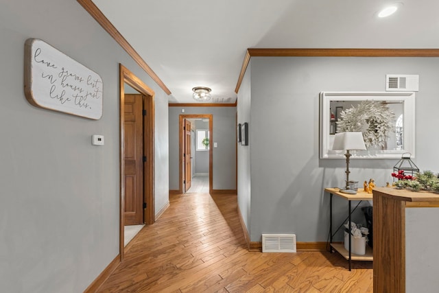 hallway featuring light wood-type flooring and crown molding