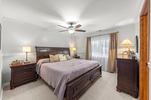 carpeted bedroom featuring ceiling fan and ornamental molding