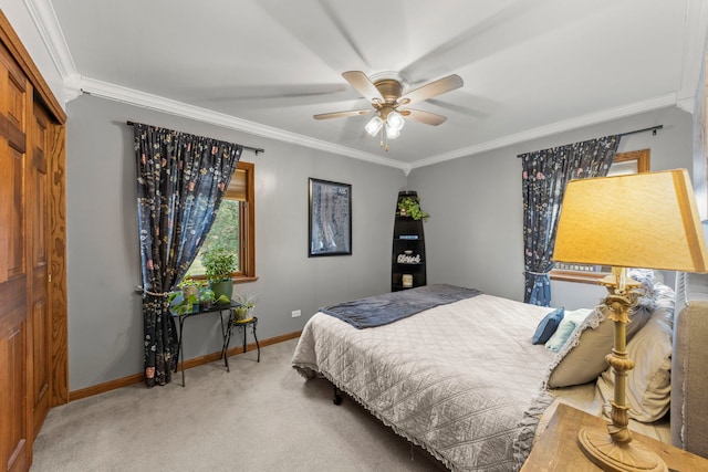 bedroom featuring a closet, ceiling fan, crown molding, and light carpet