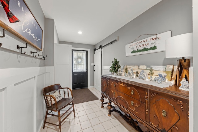 tiled foyer entrance featuring a barn door