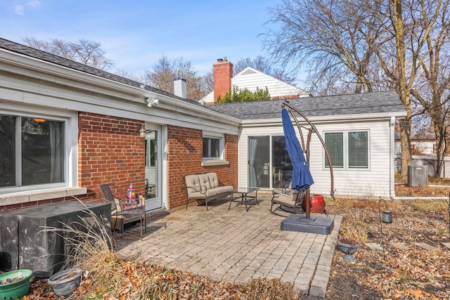 rear view of house featuring an outdoor living space and a patio