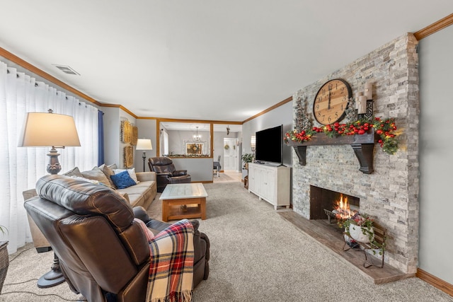 living room featuring a fireplace, light colored carpet, crown molding, and a notable chandelier