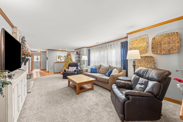 living room with plenty of natural light, light colored carpet, and crown molding