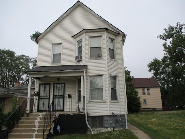 view of front of house with cooling unit, a front lawn, and a porch