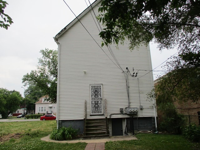 view of property exterior featuring a lawn