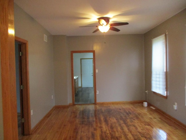 unfurnished room with ceiling fan and hardwood / wood-style floors